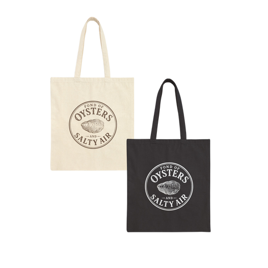 Two canvas tote bags on a plain white background: one natural cream bag and one black bag, each printed with a circular logo reading ' fond of OYSTERS and SALTY AIR' with an oyster illustration.