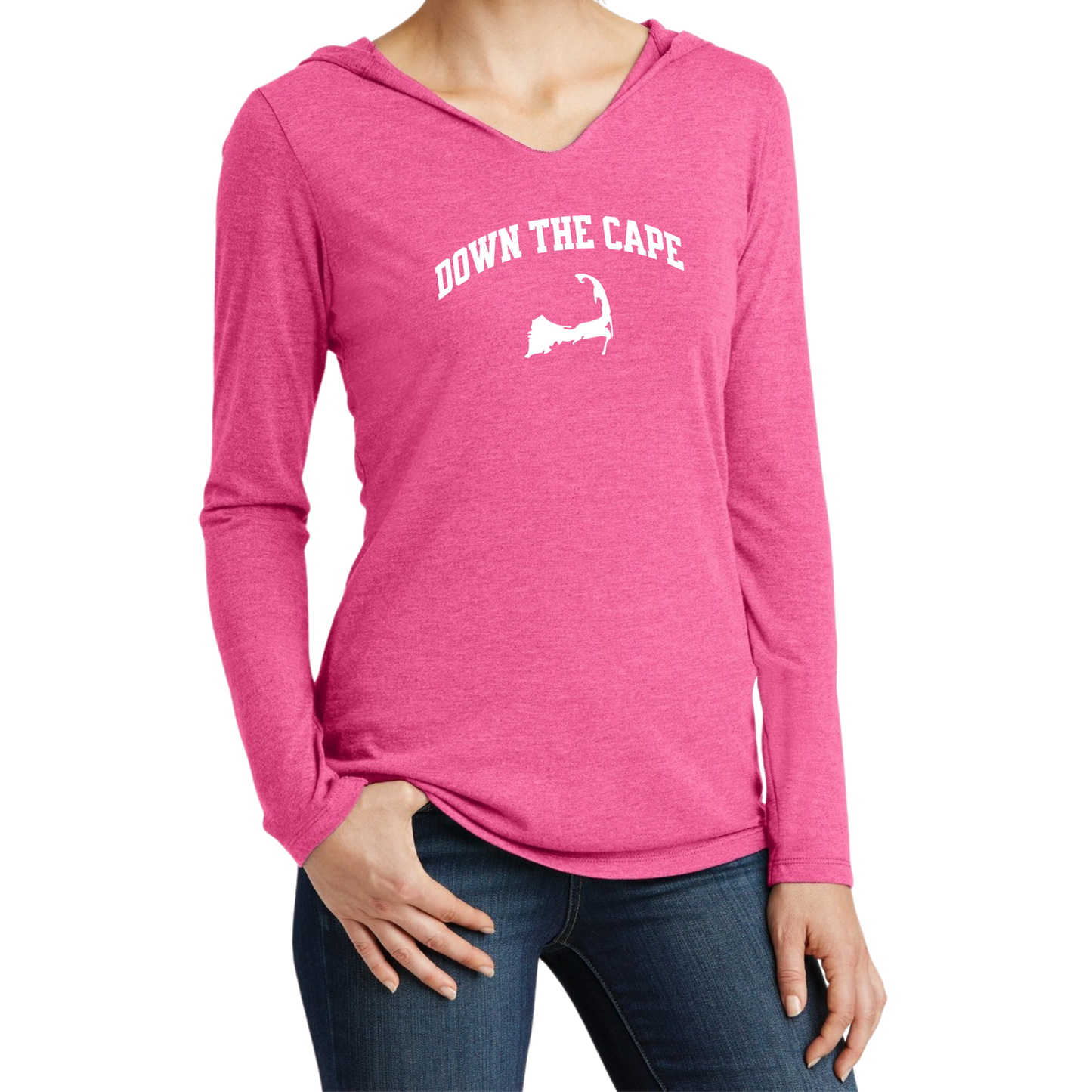 A woman wearing a heather pink long-sleeve V-neck hoodie with 'DOWN THE CAPE.' and a white silhouette graphic on the chest, paired with dark blue jeans, against a plain white background.